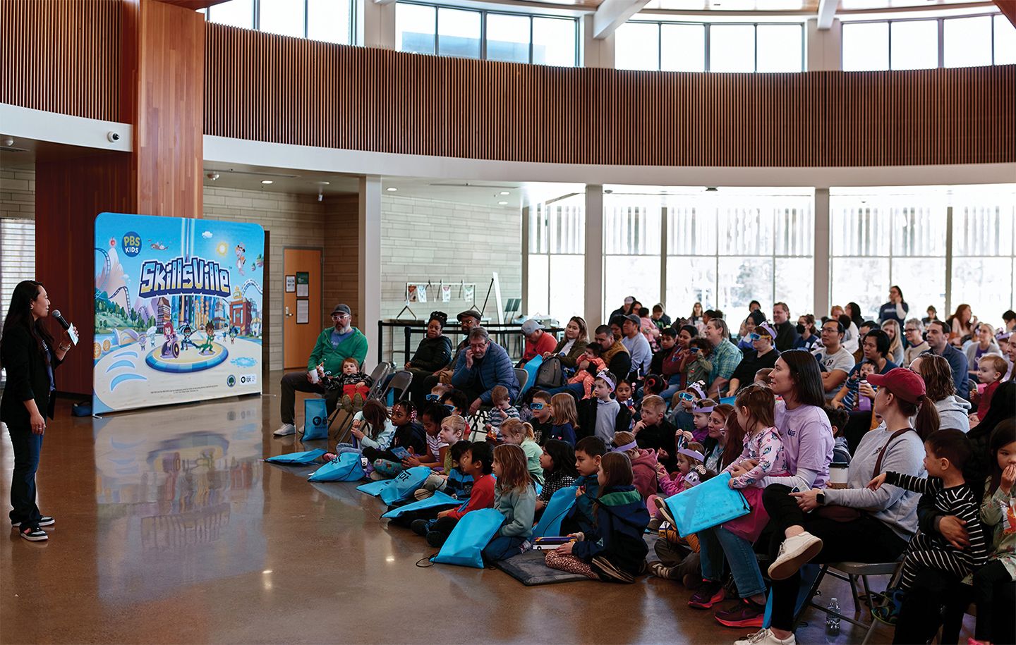 crowd of people listening to a presenter talk about Skillsville
